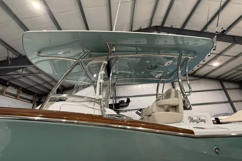  Yacht Photos Pics 2021 Mag Bay 33 CC boat with sleek design and modern features in a showroom.