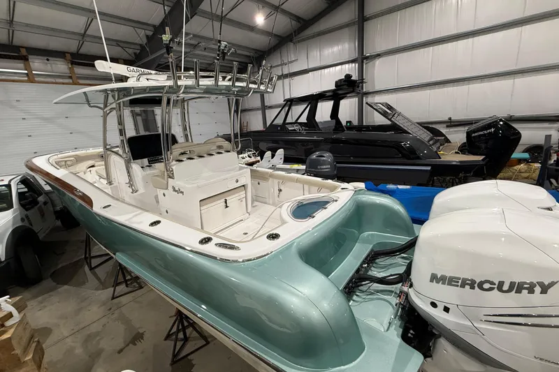  Yacht Photos Pics 2021 Mag Bay 33 CC boat with Mercury engines in a storage facility.