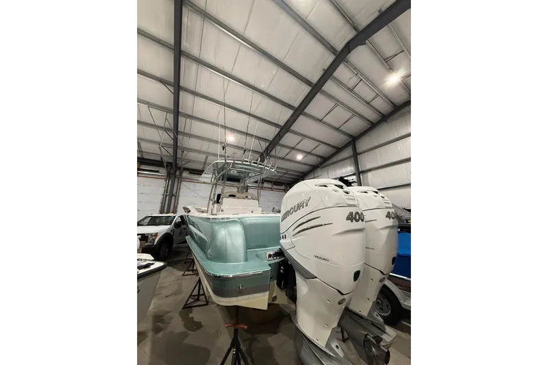  Yacht Photos Pics 2021 Mag Bay 33 CC boat with twin Mercury 400 engines in a storage facility.