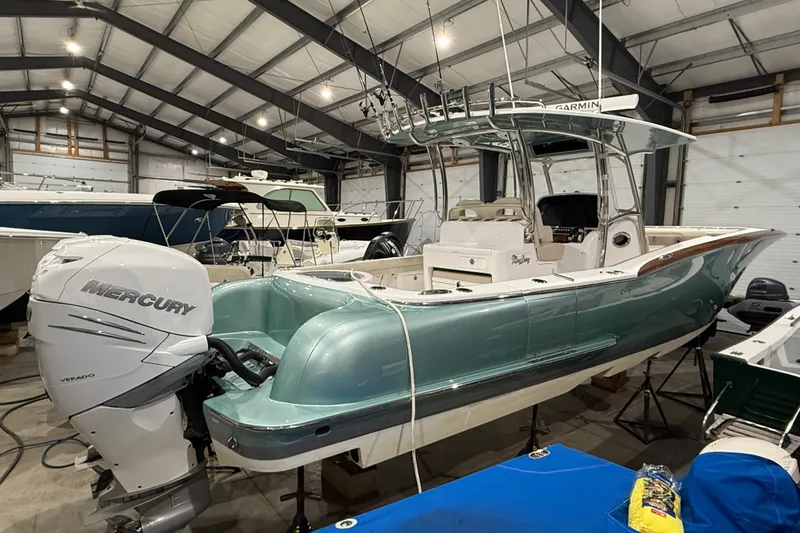  Yacht Photos Pics 2021 Mag Bay 33 CC boat with Mercury engine in storage facility.