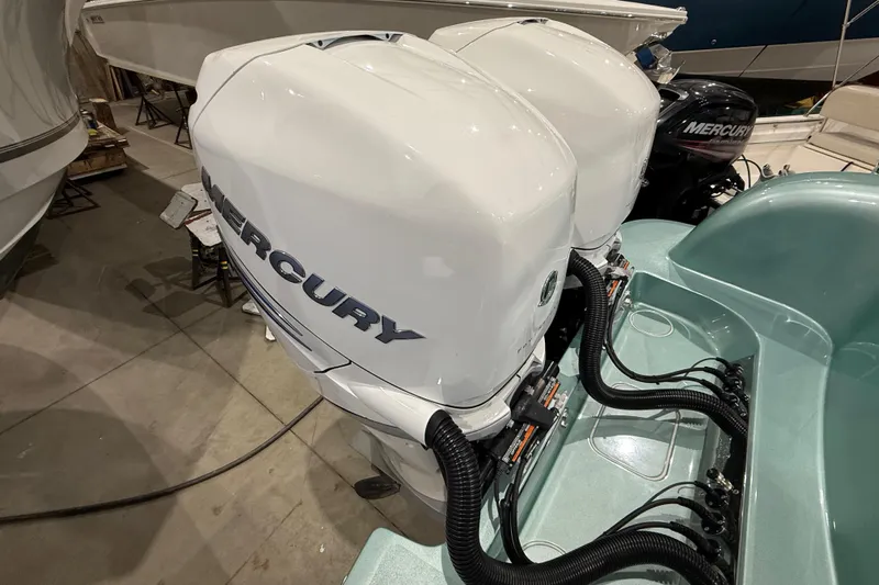  Yacht Photos Pics 2021 Mag Bay 33 CC with dual Mercury outboard engines in a showroom.