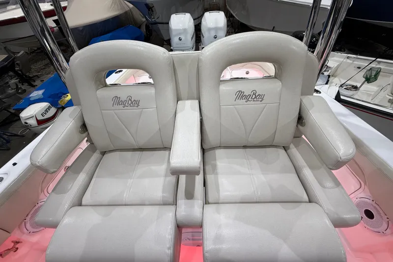  Yacht Photos Pics 2021 Mag Bay 33 CC boat seats with logo, featuring luxurious white upholstery.