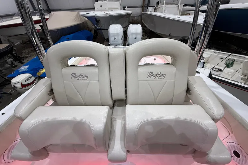  Yacht Photos Pics 2021 Mag Bay 33 CC boat seats in showroom, featuring elegant white upholstery.