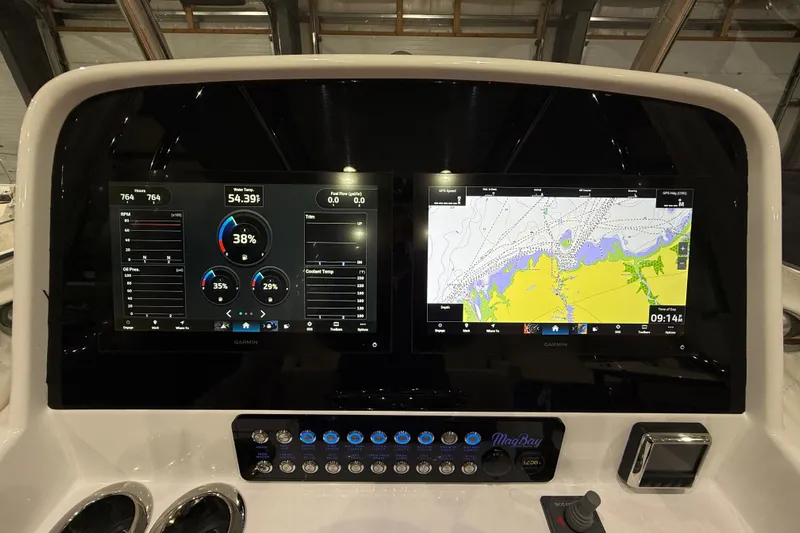 Yacht Photos Pics 2021 Mag Bay 33 CC dashboard with dual Garmin displays and navigation controls.