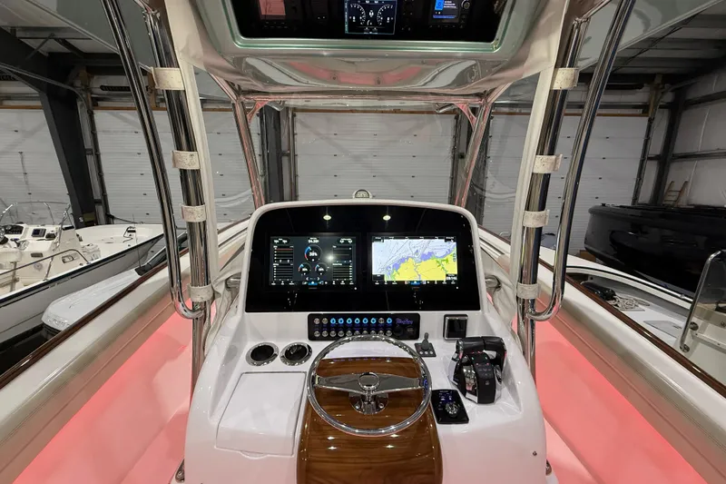  Yacht Photos Pics 2021 Mag Bay 33 CC boat console with navigation screens and controls in a showroom.