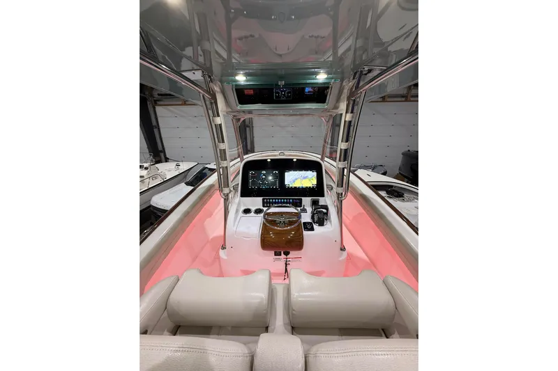  Yacht Photos Pics 2021 Mag Bay 33 CC boat interior with illuminated console and navigation screens.