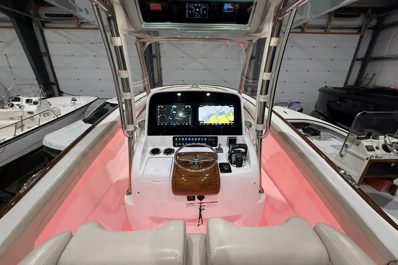  Yacht Photos Pics 2021 Mag Bay 33 CC boat interior with illuminated console and navigation display.