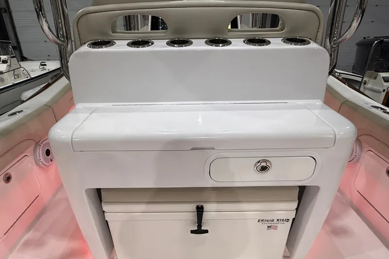  Yacht Photos Pics 2021 Mag Bay 33 CC boat console with rod holders and storage compartment.