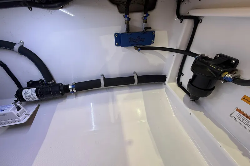  Yacht Photos Pics Engine compartment of 2021 Mag Bay 33 CC boat, showcasing hoses and components.