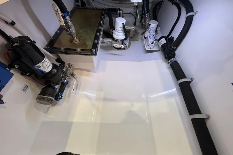  Yacht Photos Pics Engine compartment of 2021 Mag Bay 33 CC boat, showcasing mechanical components and piping.