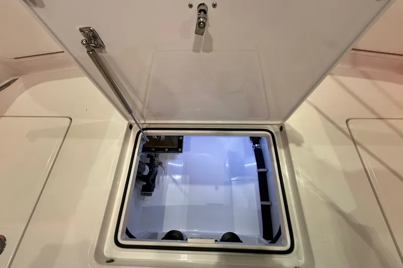  Yacht Photos Pics Open hatch on 2021 Mag Bay 33 CC boat, revealing interior compartment.