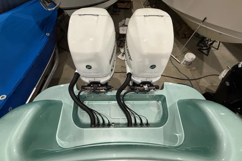  Yacht Photos Pics 2021 Mag Bay 33 CC boat with twin outboard engines in a showroom.