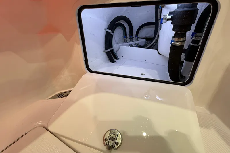  Yacht Photos Pics 2021 Mag Bay 33 CC boat compartment with visible plumbing and storage area.