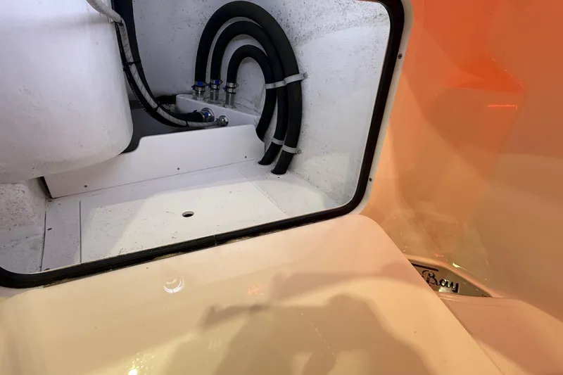  Yacht Photos Pics 2021 Mag Bay 33 CC boat interior compartment with hoses and fittings.