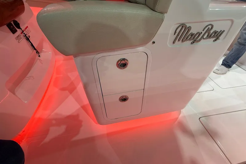  Yacht Photos Pics 2021 Mag Bay 33 CC boat interior with red LED lighting and storage compartments.
