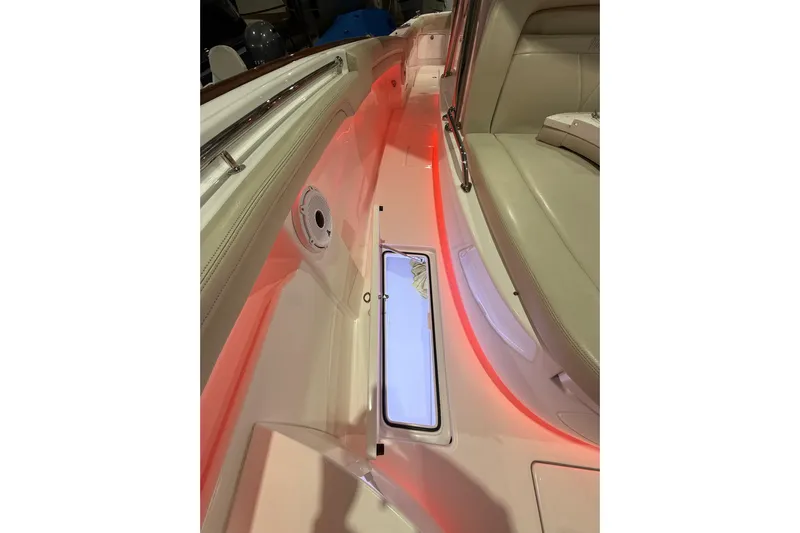  Yacht Photos Pics 2021 Mag Bay 33 CC boat interior with red LED lighting and cushioned seating.