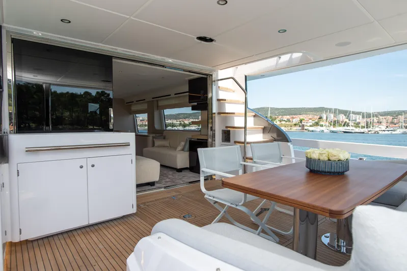 Prewi Yacht Photos Pics Luxurious 2022 Azimut 78 FLY yacht interior with elegant dining area and scenic marina view.
