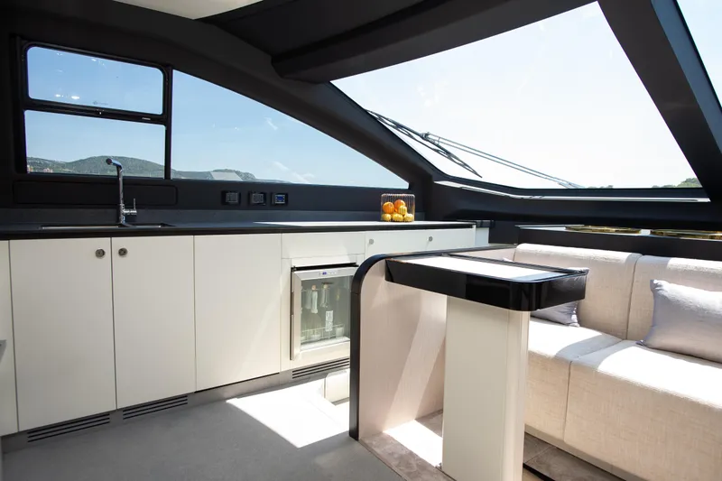 Prewi Yacht Photos Pics Luxurious interior of 2022 Azimut 78 FLY yacht with modern kitchen and seating area.