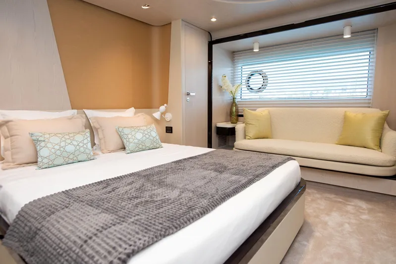 Prewi Yacht Photos Pics Luxurious bedroom interior of 2022 Azimut 78 FLY yacht with modern decor and cozy seating.