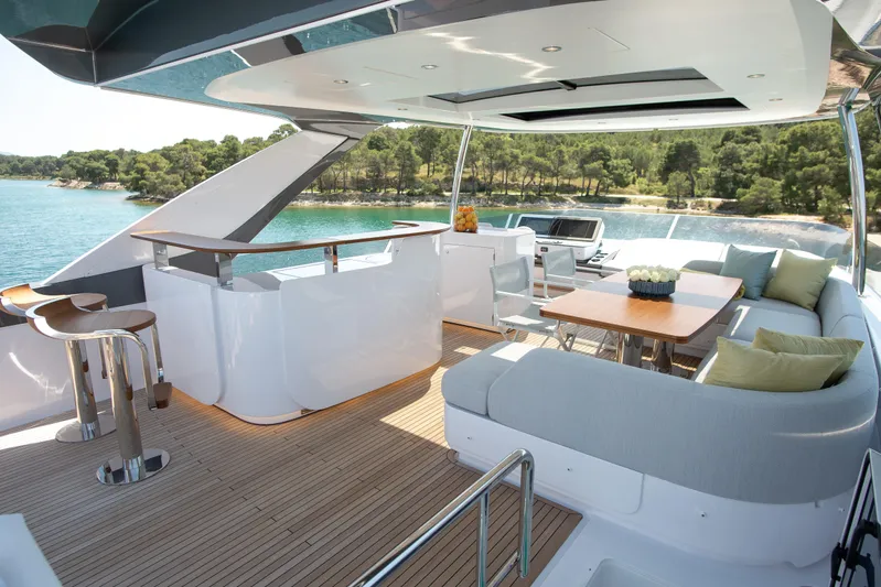 Prewi Yacht Photos Pics Luxurious 2022 Azimut 78 FLY yacht with elegant outdoor seating and scenic ocean view.