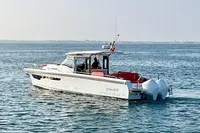 Nimbus T 11 boat cruising on open water, 2023 model, clear sky background.