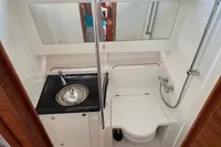 Compact bathroom in 2023 Nimbus T 11 boat with sink, toilet, and shower.