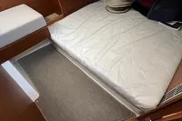 Interior cabin of 2023 Nimbus T 11 boat with bed and carpeted floor.