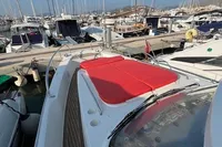 2023 Nimbus T 11 boat with red sunbed, docked in a marina.