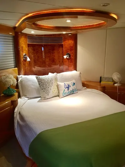  Yacht Photos Pics Luxurious bedroom interior of a 2004 McKinna 58 yacht with elegant wood accents.
