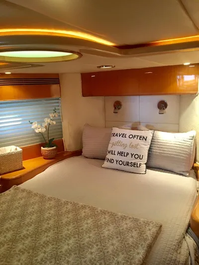  Yacht Photos Pics Luxurious bedroom in a 2004 McKinna 58 yacht with elegant decor and cozy bedding.