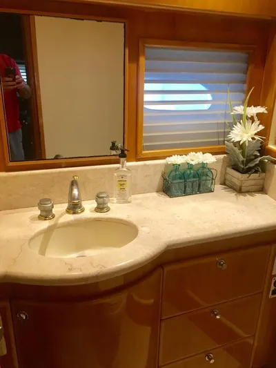  Yacht Photos Pics Luxurious bathroom in a 2004 McKinna 58 yacht with marble countertop and elegant decor.