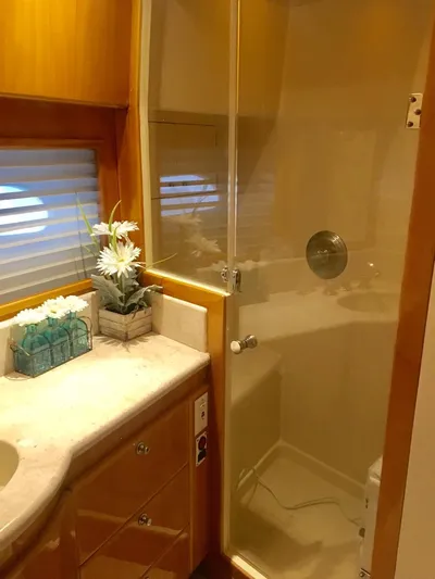 Yacht Photos Pics Luxurious bathroom in 2004 McKinna 58 yacht with shower and elegant decor.