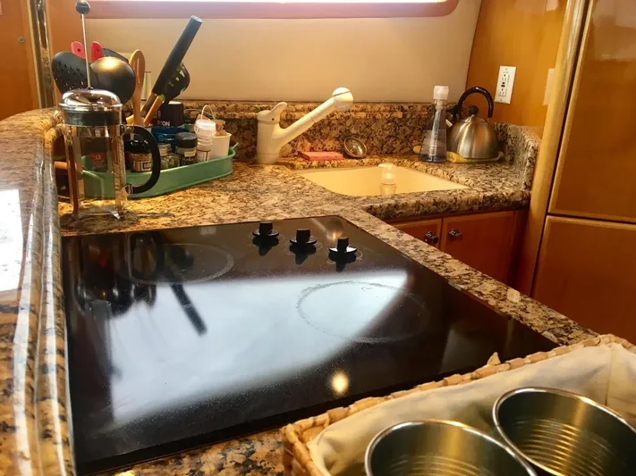  Yacht Photos Pics Luxurious 2004 McKinna 58 yacht kitchen with granite countertops and modern appliances.