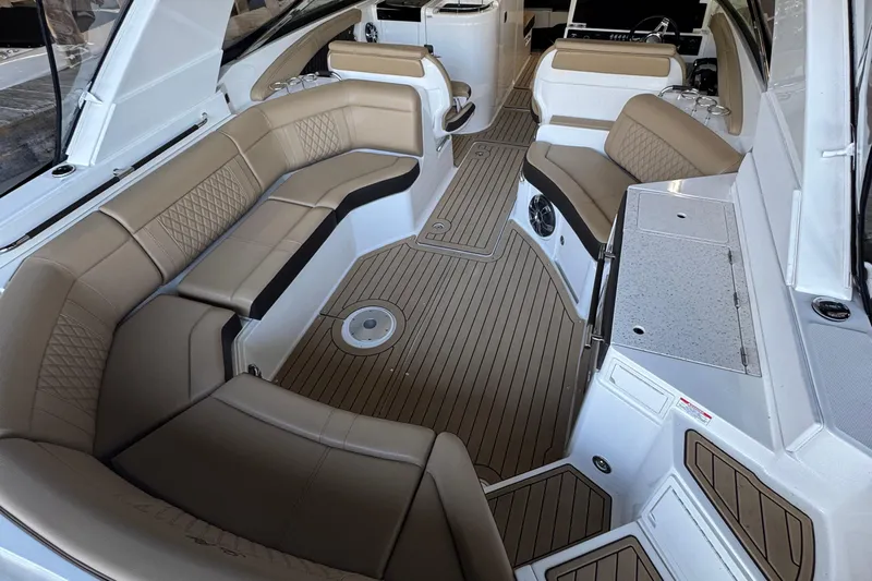  Yacht Photos Pics Luxurious interior of 2020 Sea Ray SLX 350 boat with tan seating and wood flooring.
