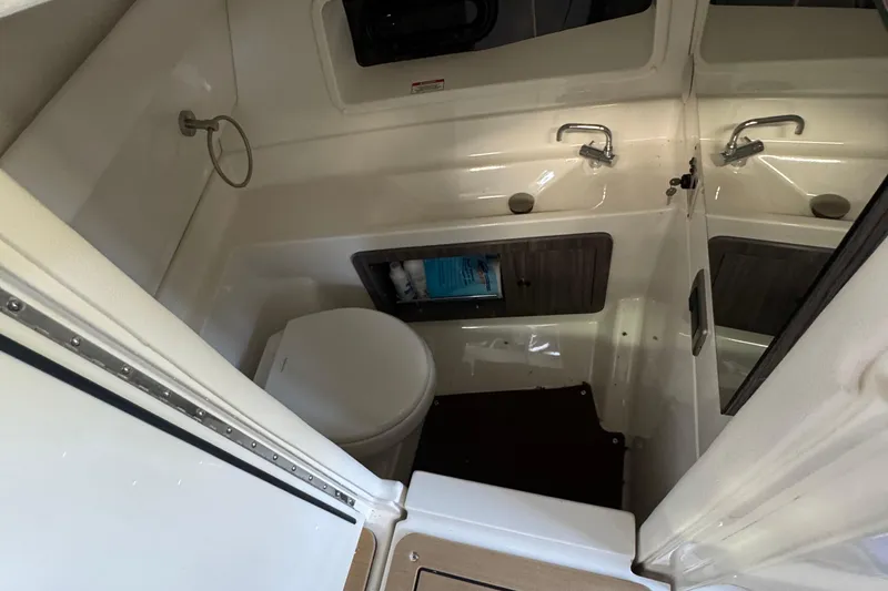  Yacht Photos Pics 2020 Sea Ray SLX 350 boat bathroom with toilet, sink, and storage cabinet.
