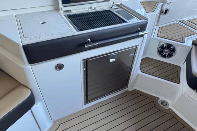  Yacht Photos Pics 2020 Sea Ray SLX 350 boat interior with grill and refrigerator on teak flooring.