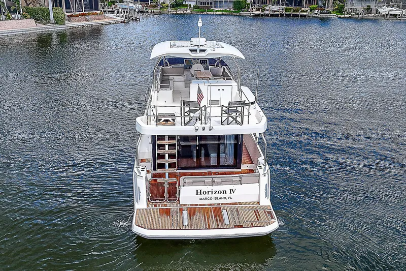 Horizon IV Yacht Photos Pics 2020 Beneteau Swift Trawler 47 on water, rear view, named Horizon IV.