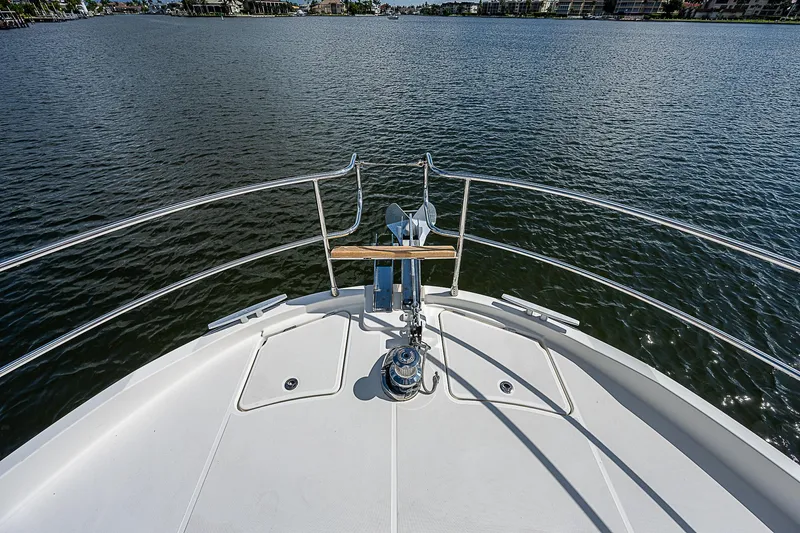 Horizon IV Yacht Photos Pics Bow view of 2020 Beneteau Swift Trawler 47 on calm water.