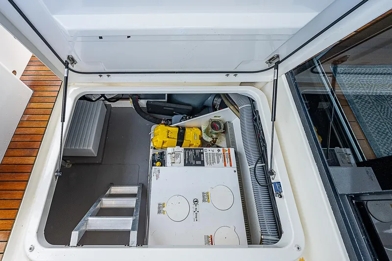 Horizon IV Yacht Photos Pics Engine compartment of 2020 Beneteau Swift Trawler 47 with visible equipment and access ladder.