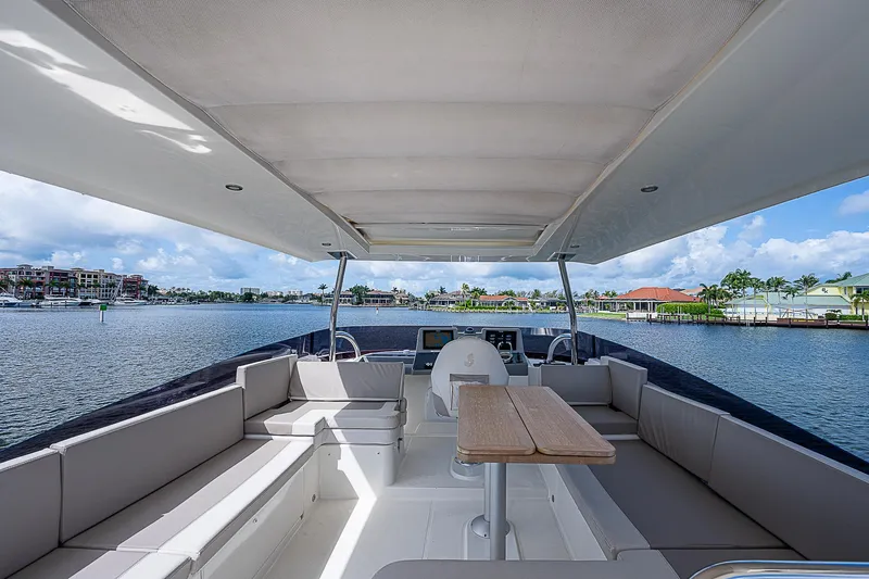Horizon IV Yacht Photos Pics 2020 Beneteau Swift Trawler 47, spacious deck with seating, overlooking serene waterfront.
