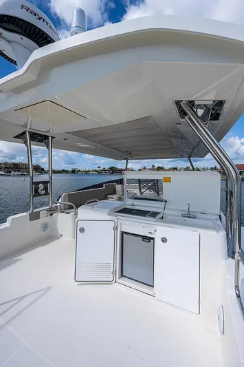 Horizon IV Yacht Photos Pics 2020 Beneteau Swift Trawler 47 flybridge with outdoor kitchen and seating area.