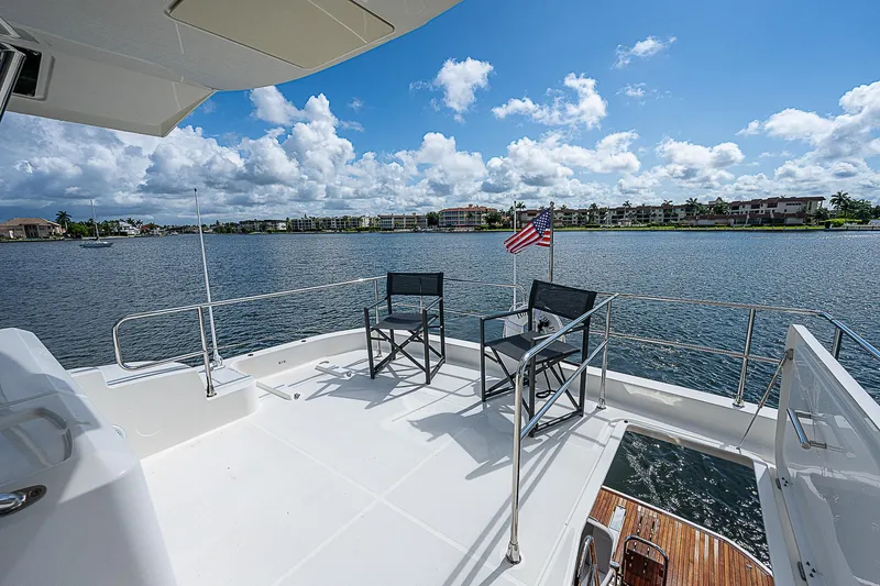 Horizon IV Yacht Photos Pics Beneteau Swift Trawler 47, 2020 model, featuring a spacious deck with chairs and scenic water view.