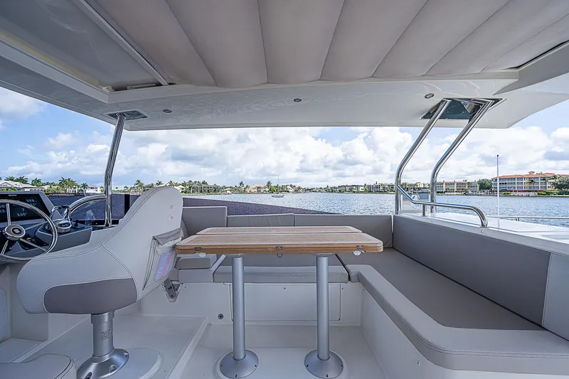Horizon IV Yacht Photos Pics 2020 Beneteau Swift Trawler 47 interior with seating and table, overlooking water.