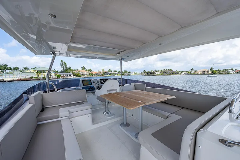 Horizon IV Yacht Photos Pics 2020 Beneteau Swift Trawler 47, spacious deck with seating, overlooking serene waterfront.