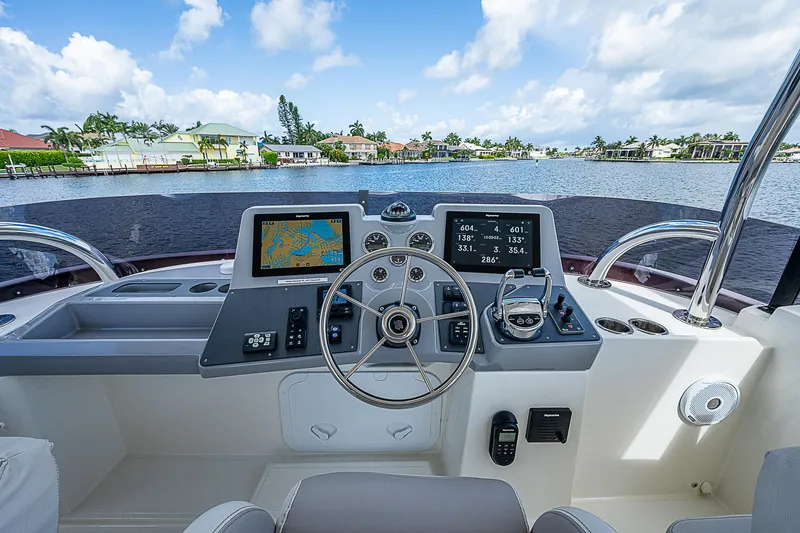 Horizon IV Yacht Photos Pics Helm of 2020 Beneteau Swift Trawler 47 with navigation screens and steering wheel.