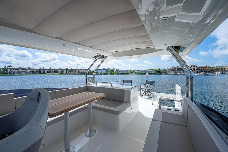 Horizon IV Yacht Photos Pics 2020 Beneteau Swift Trawler 47 interior with seating, table, and scenic water view.