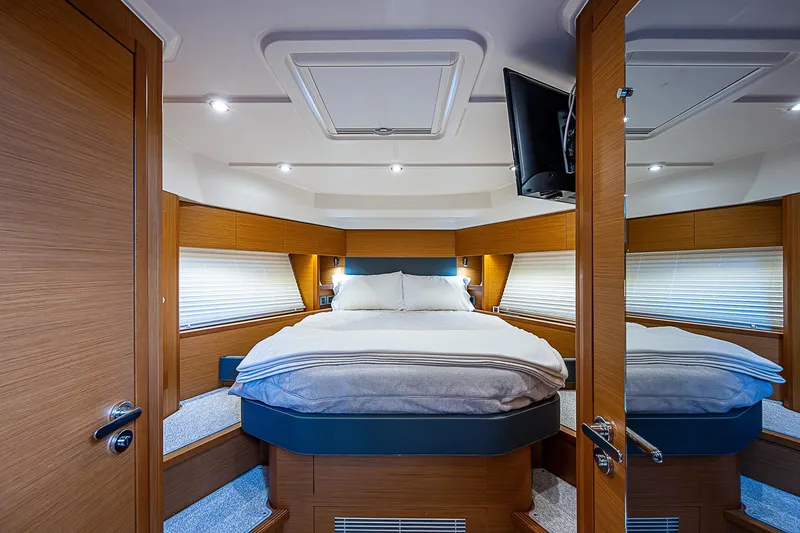 Horizon IV Yacht Photos Pics Luxurious cabin interior of 2020 Beneteau Swift Trawler 47 with cozy bed and modern design.