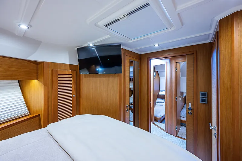 Horizon IV Yacht Photos Pics 2020 Beneteau Swift Trawler 47 cabin interior with wood paneling and modern amenities.