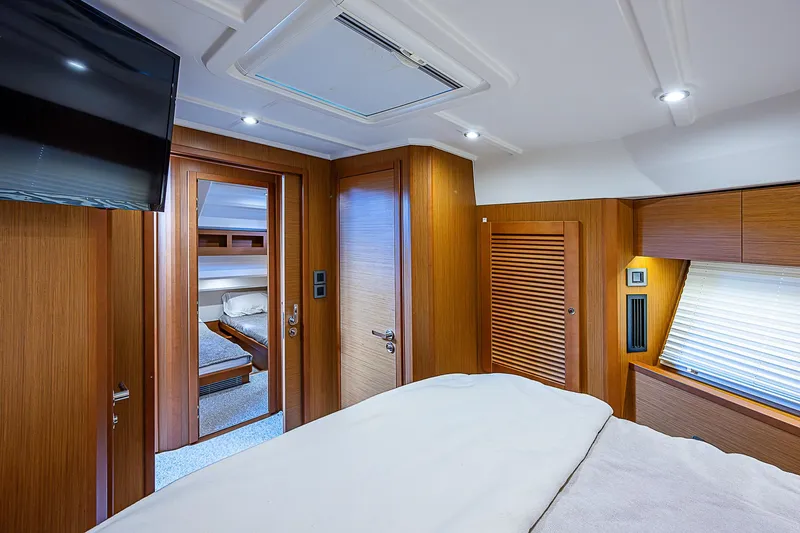Horizon IV Yacht Photos Pics Interior of 2020 Beneteau Swift Trawler 47, featuring a cozy bedroom with wooden accents.