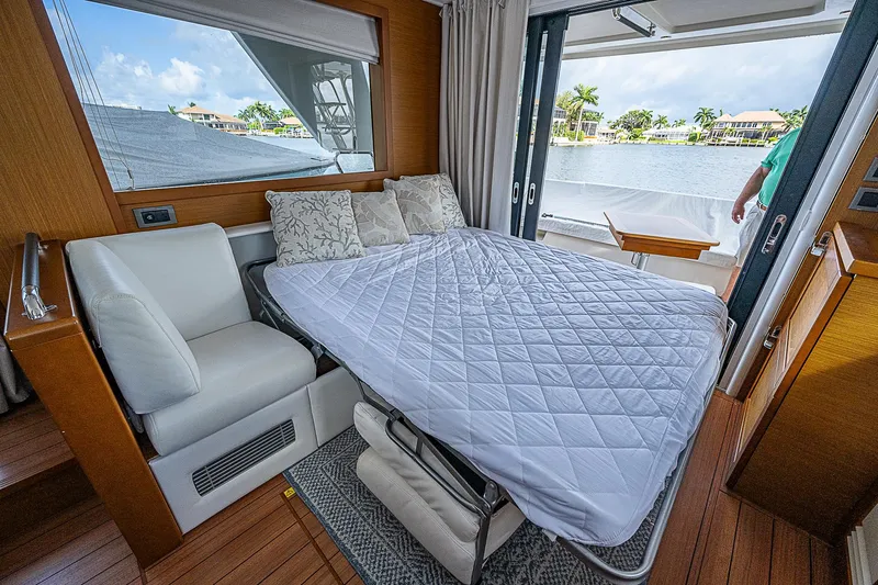 Horizon IV Yacht Photos Pics 2020 Beneteau Swift Trawler 47 interior with convertible bed and scenic water view.